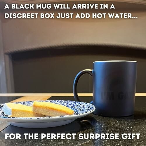 Black mug with text, plate with cake, surprise gift message.