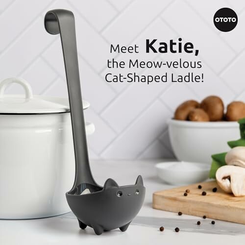 Cat-shaped ladle standing upright on kitchen counter.