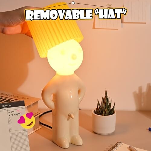 Lamp with a human figure shape and removable hat shade.