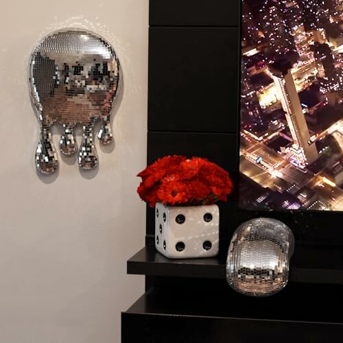 Mirror art pieces with red flowers in dice vase